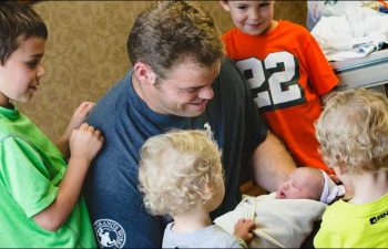 father holding newborn baby