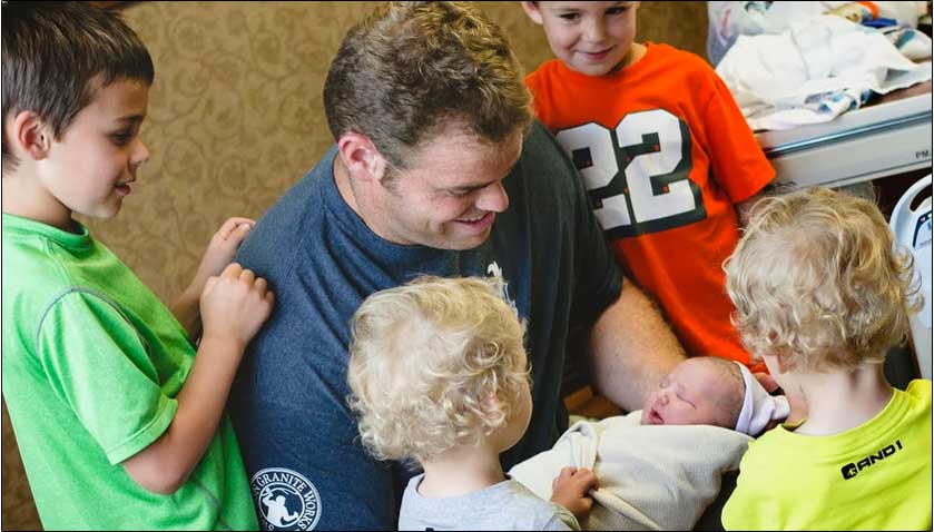 father holding newborn baby