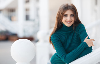 long haired brunette with a beautiful smile in a turquoise sweater, 