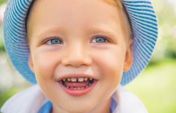 Cute Little Boy With Blue Eyes Closeup. Portrait Of Happy Kid Ou, 